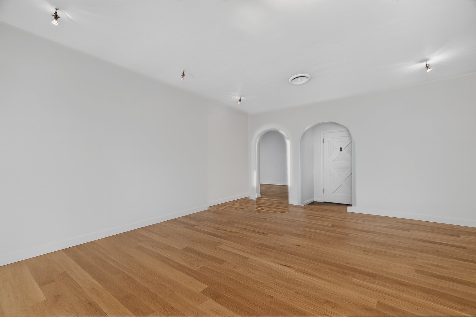 The living room shown empty, digitally recreated from the staged photo