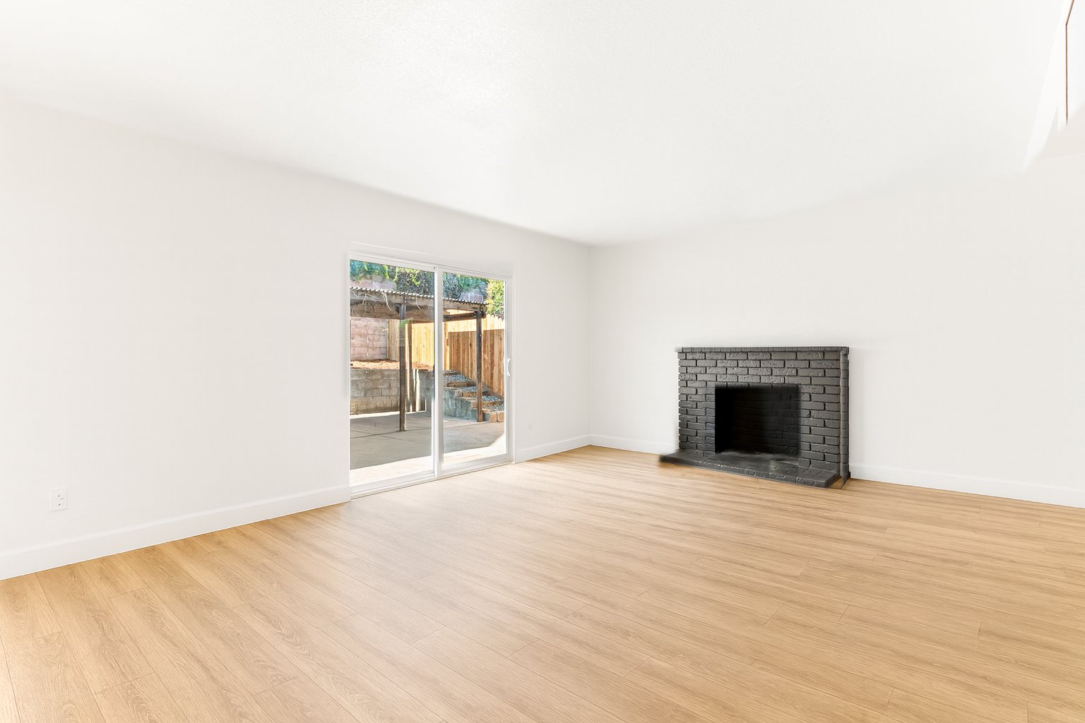 The living room shown empty, digitally recreated from the staged photo